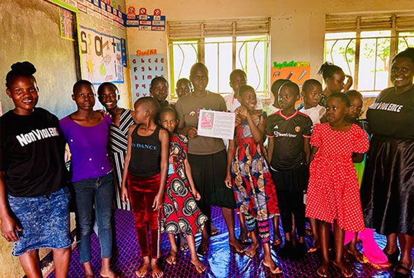 Uganda students in a classroom together with their teacher during the Youth Leader Camp 2025.
